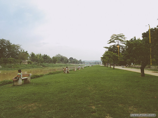 People sitting by the river.